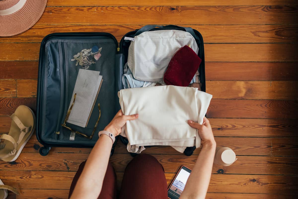 Folding shirts onto a travel bag