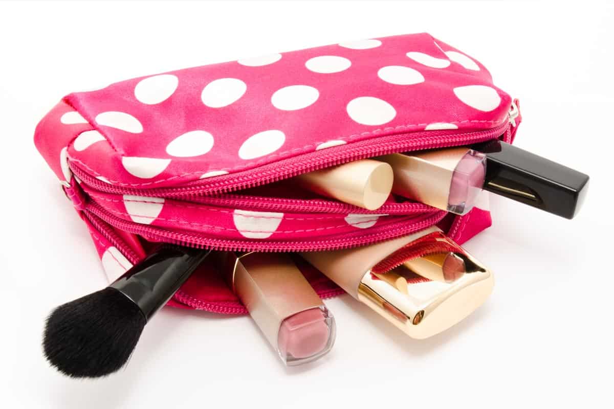 Pink make up bag with cosmetics