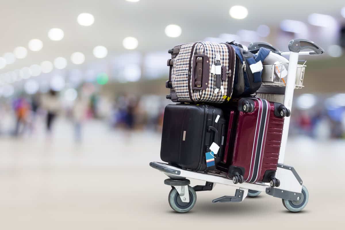 focused photo of a luggage on top of each other on a luggage cart