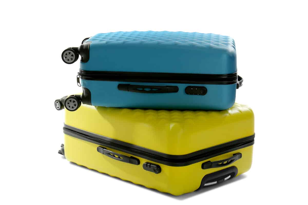 sky blue, bright yellow carry on suitcase, on top of each other