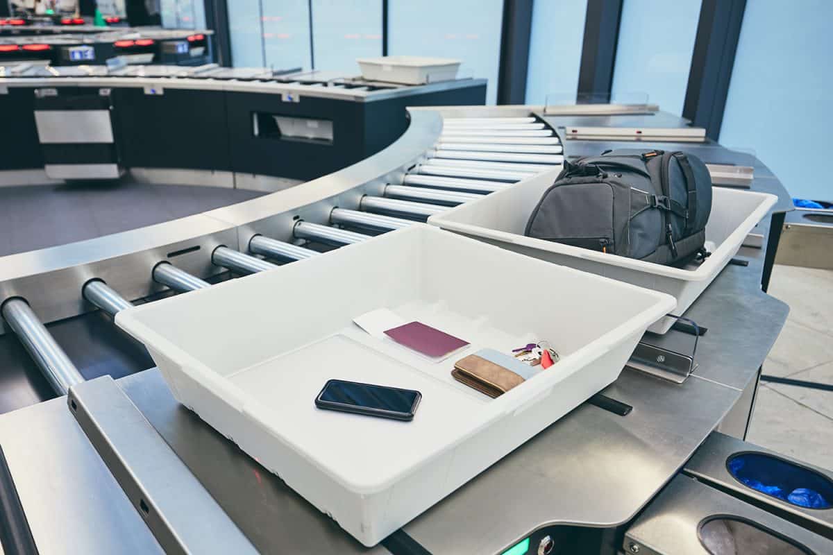 Airport security check containers with personal belongings of passengers