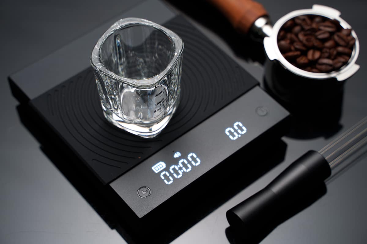 Coffee bean inside the espresso glass scale shot on a digital coffee scale