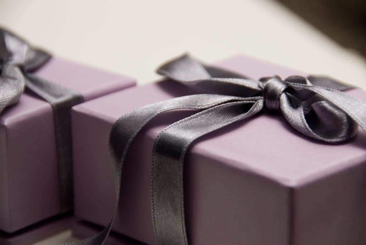 Lavender gift box with a dark purple satin bow