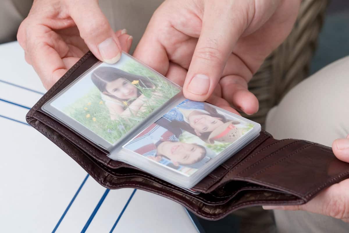 close up photo of a wallet and wallet size pictures inside