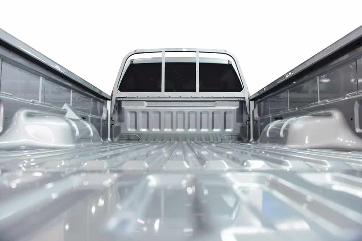 close up photo of rear pick up truck bed, grey painted pick up truck