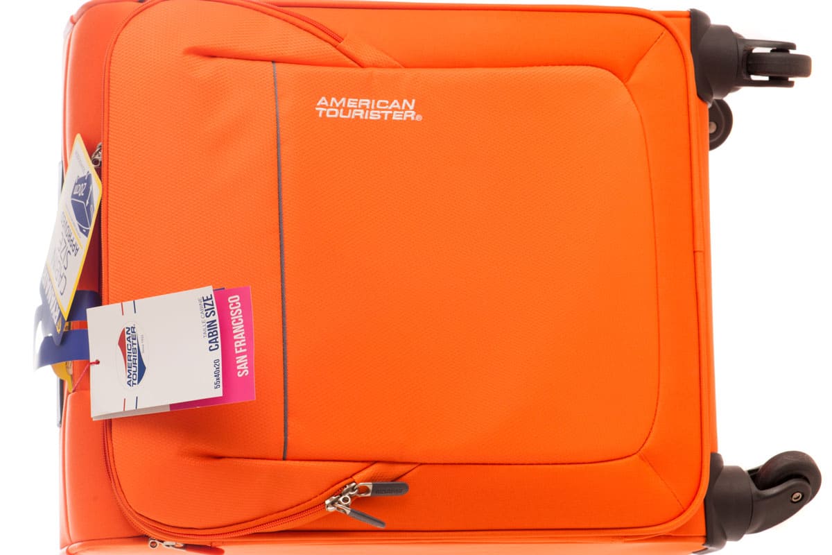 photo of an american tourister suitcase, orange colored suitcase