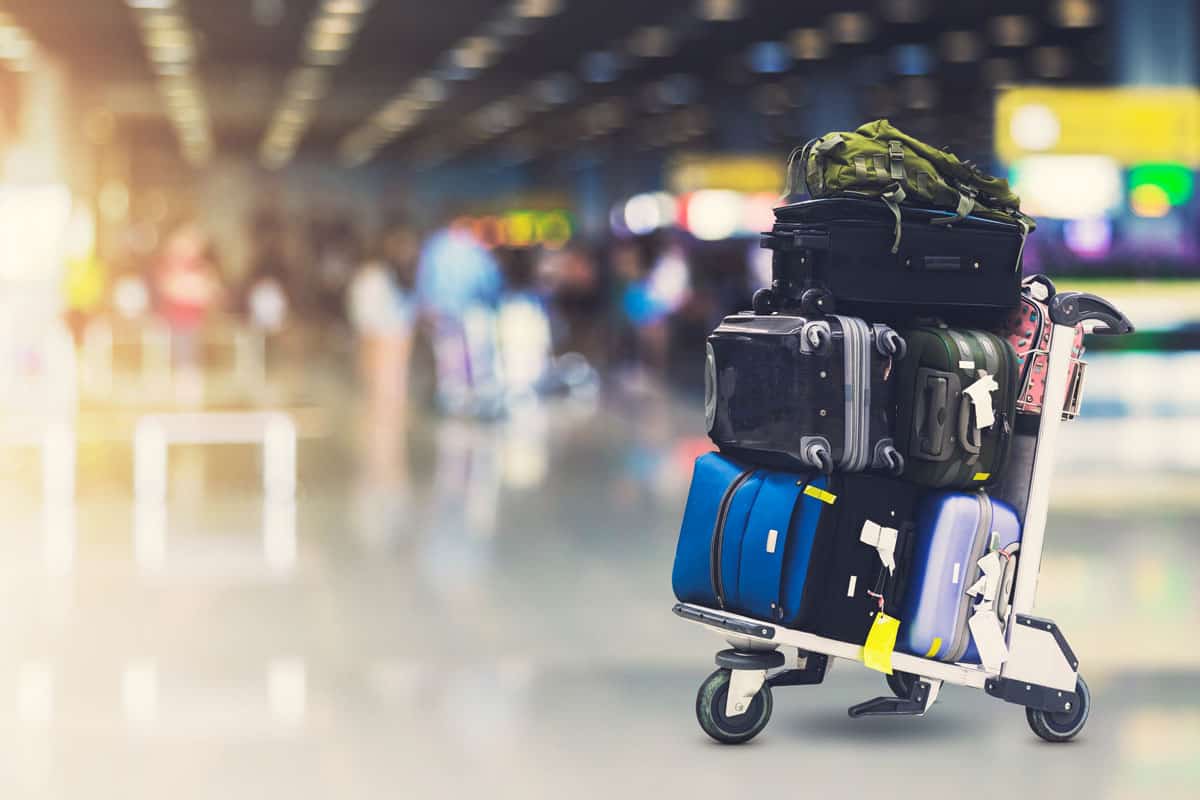 up close photo of a travel cart with luggages and suitcase on top of each other