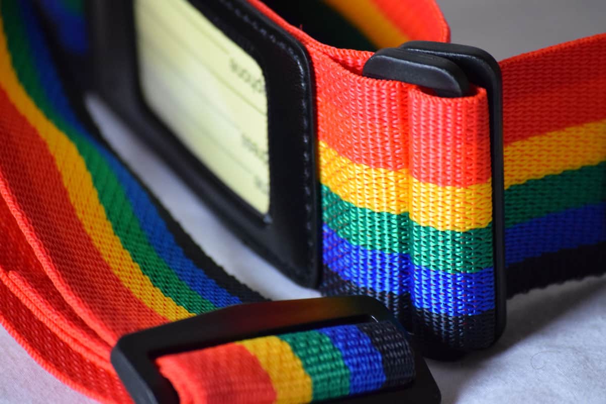 very close up photo of a luggage strap on a rainbow color