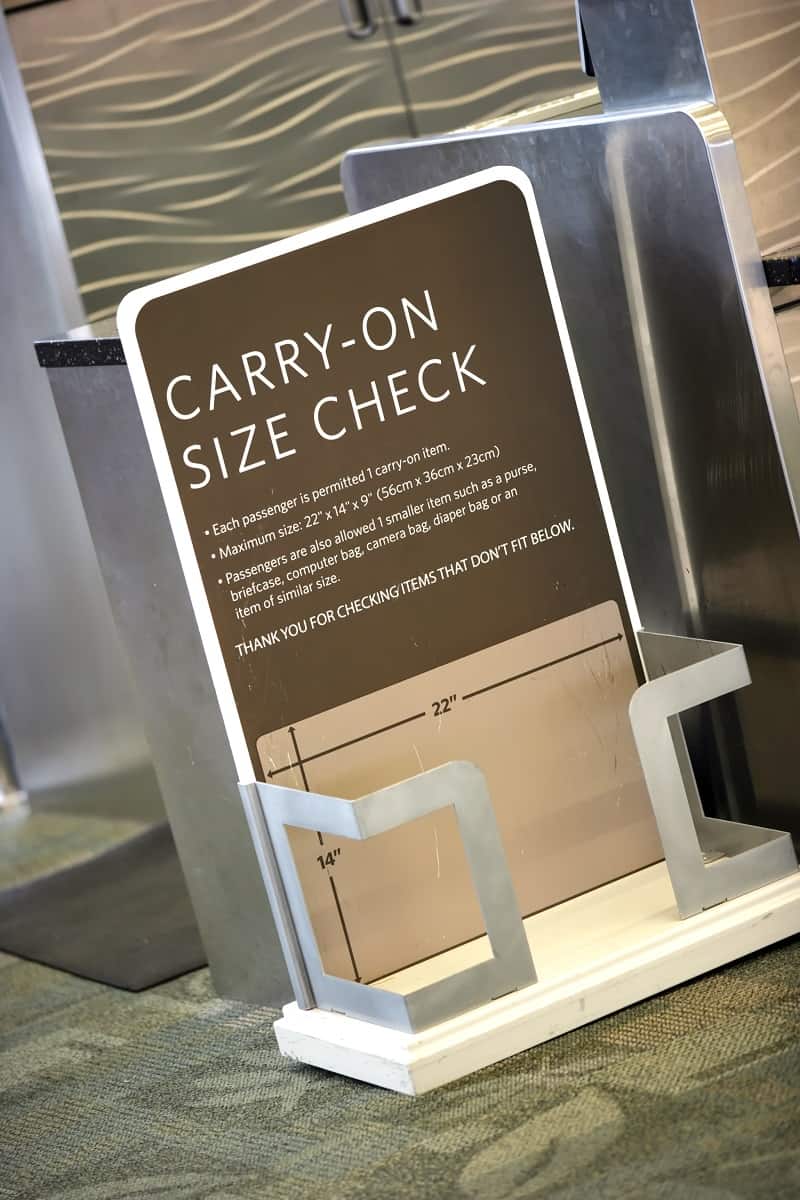 Carry-on luggage size requirements measured at airport terminal gate.