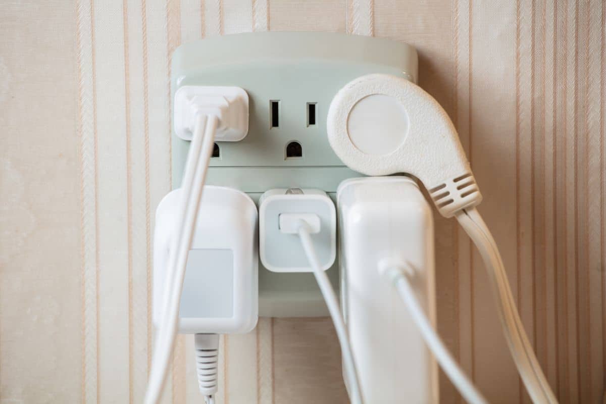 Electrical socket overloaded on wall. Concept face expression

