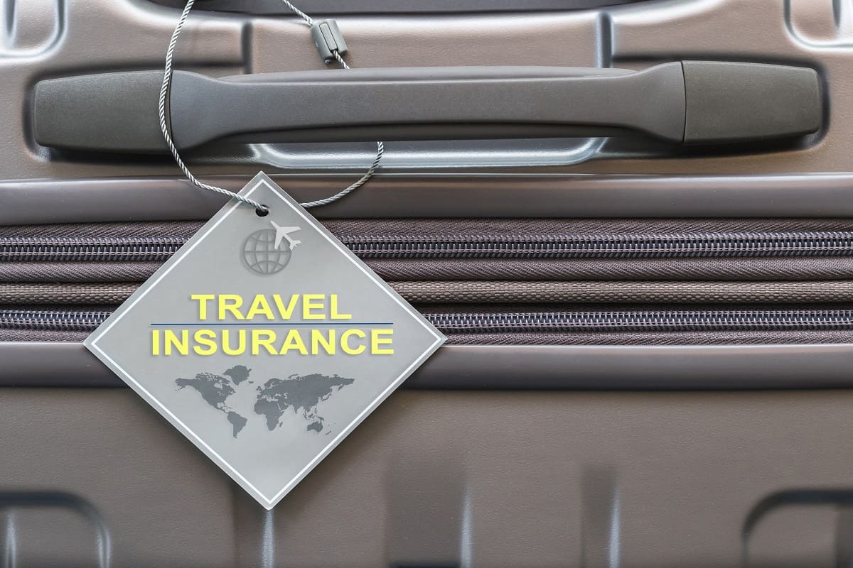 Is Away Luggage Durable? - Travel insurance protection plan for airline safety and security with tag on passenger suitcase luggage handle