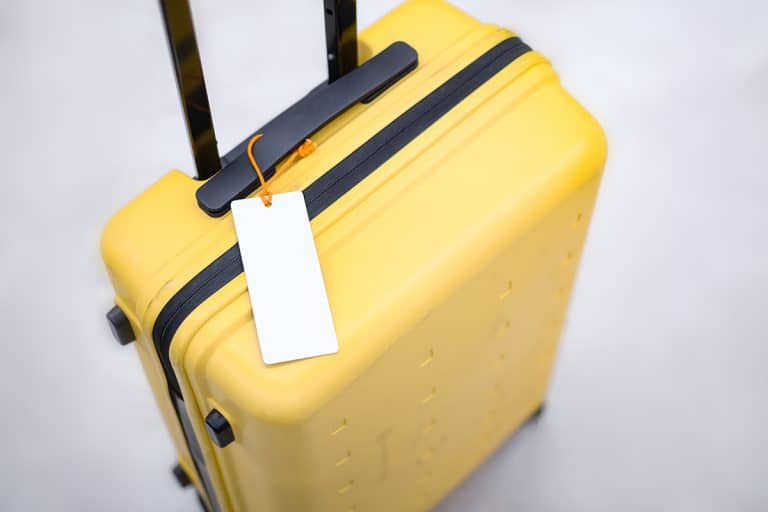 Name tag tied to yellow thick suitcase, How To Print Luggage Tags For Princess Cruise