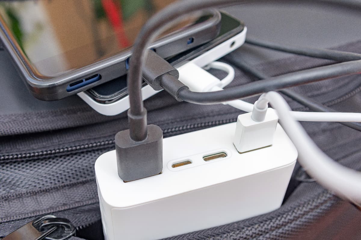 Smartphones charging with power bank on the travel bag