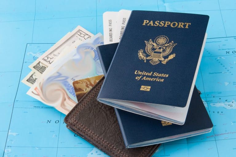 An image of a wallet and some cash and a US Passport, Should I Keep My Passport Card In My Wallet?