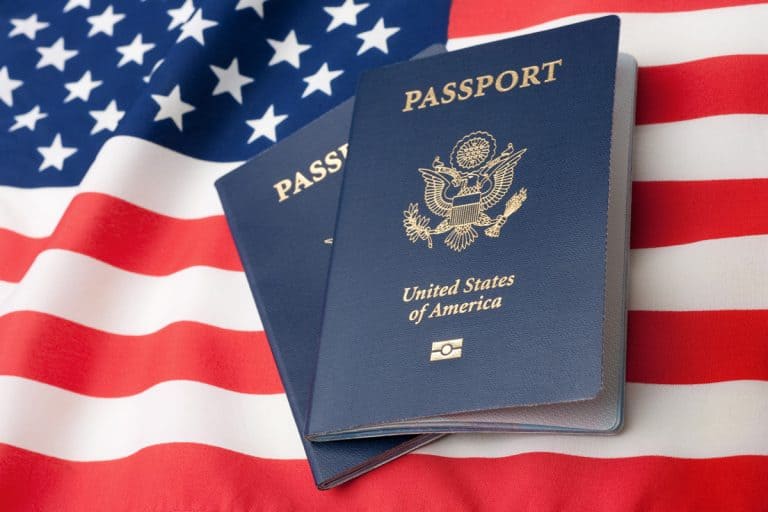 U.S. Passports on an American Stars and Stripes flag., How Long Does It Take To Get A Passport Photo?