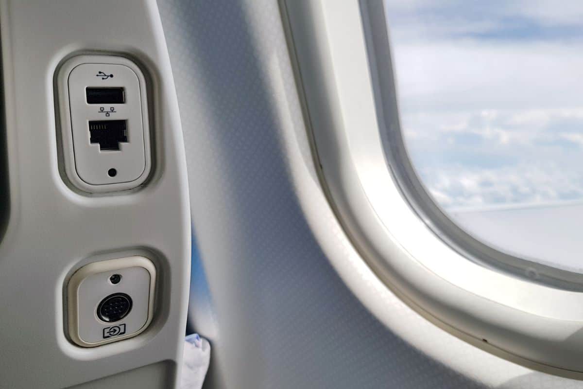USB and LAN port, socket or outlet at back of the seat on airplane flight service for passengers. Closeup of USB and Land Socket.