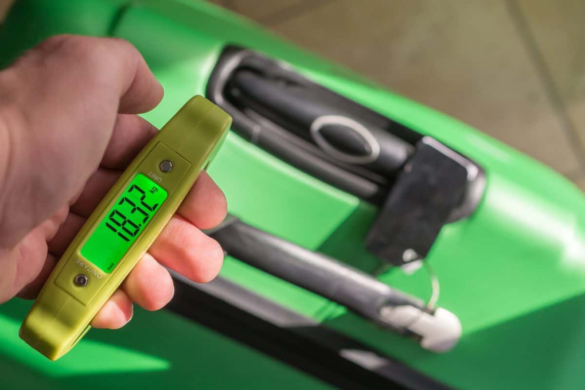 Weigh the suitcase with a luggage scale
