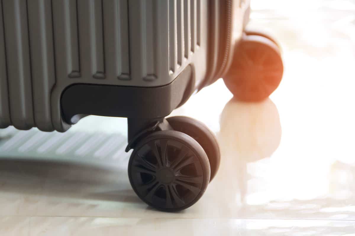 close up wheel luggage suitcase grey colored black wheels
