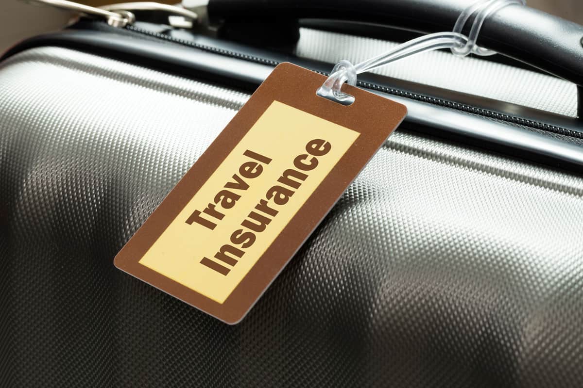 travel-insurance-luggage-tag-tied-suitcase