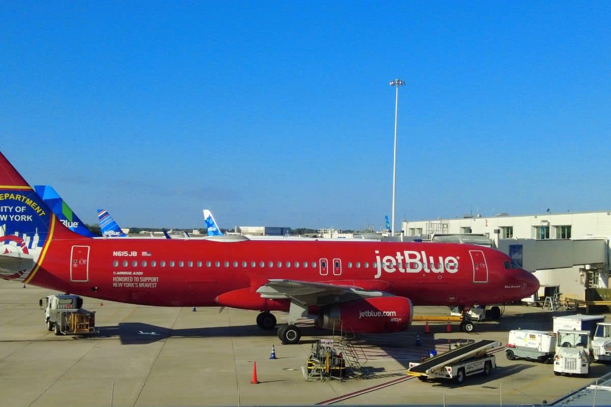 A red JetBlue plane to salute the Fire Department of the City of New York on the tarmac by the domestic terminals near the airport