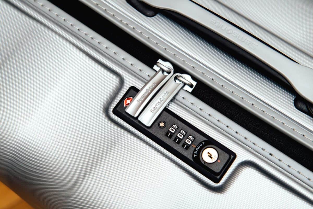 Close up detail of a Samsonite suitcase briefcase with focus on the logo and TSA combination lock password number