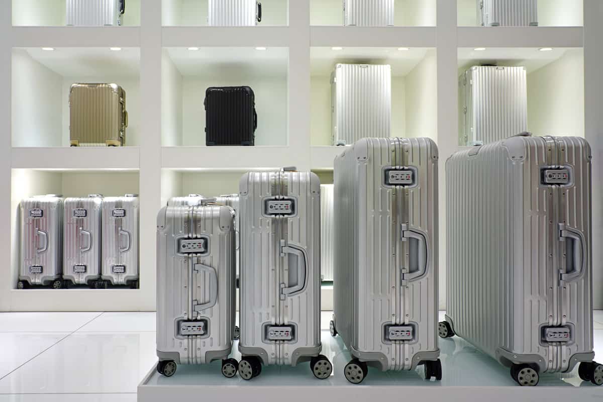 Display of colorful metal suitcases in a Rimowa store. 