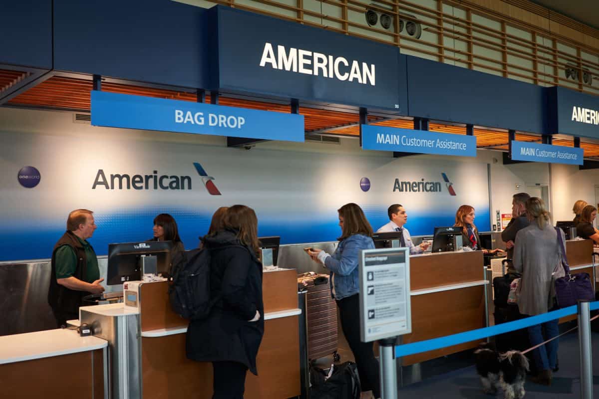 Passengers check their baggages at the American Airlines check-in desk in Portland International Airport.