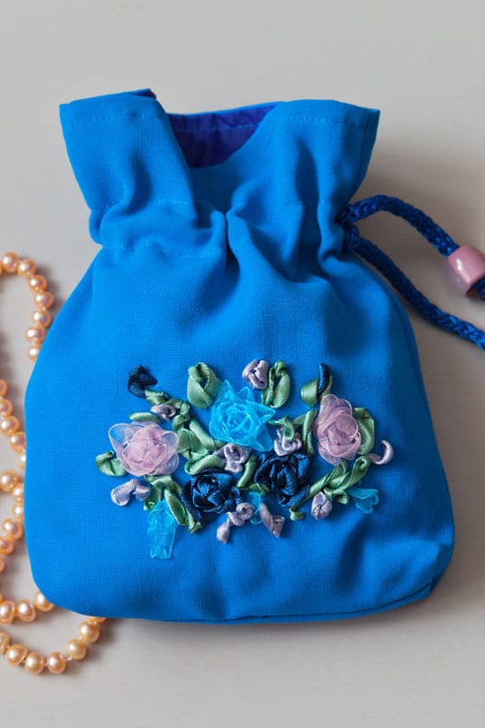 Blue gift bag for jewelry with hand-embroidered of satin ribbons and pink pearls