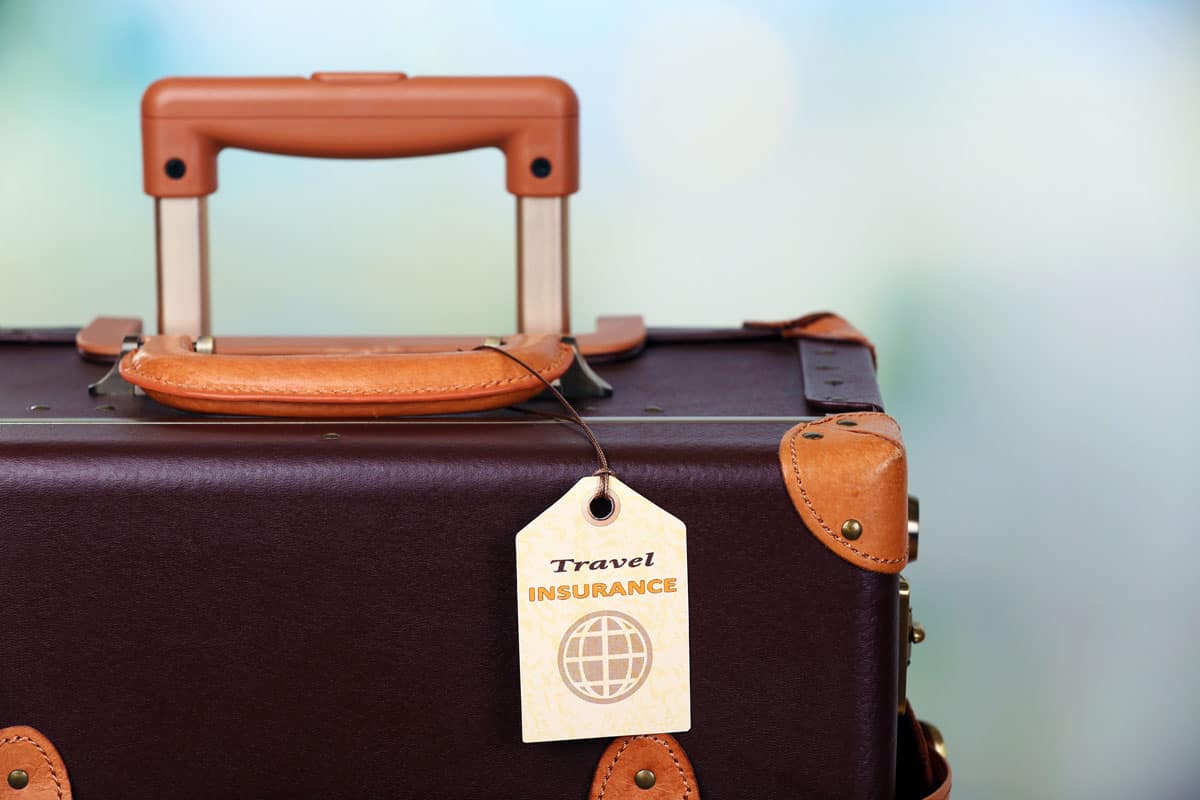 suitcase travel insurance label on light